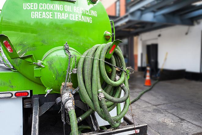 a grease trap pumping truck at a restaurant in Edinburg